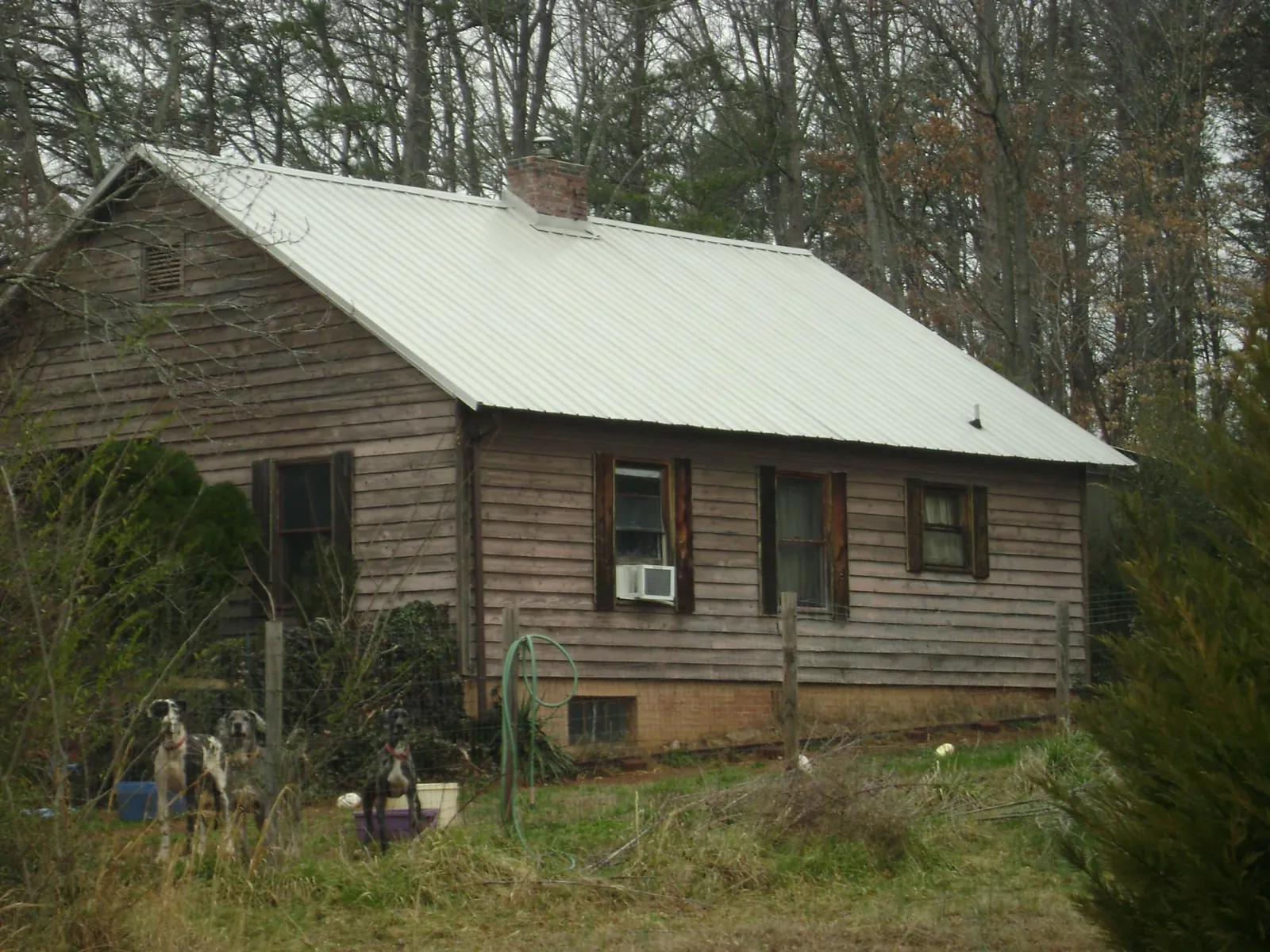 White metal roof on an old wood sided farmhouse, from a Metal Roof Installation job in Summertown